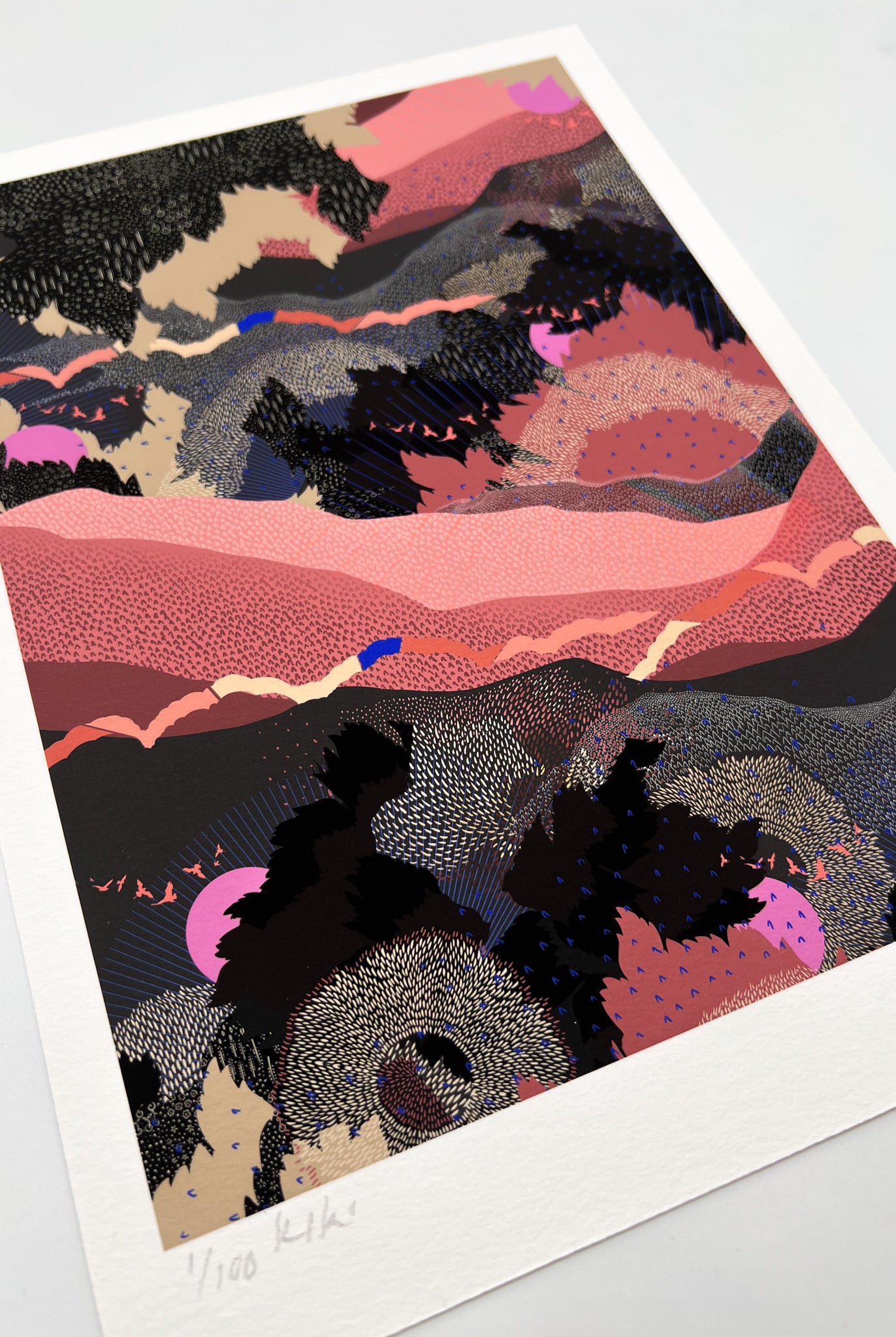 A giclee print in black and pink with a landscape design and bright pink suns