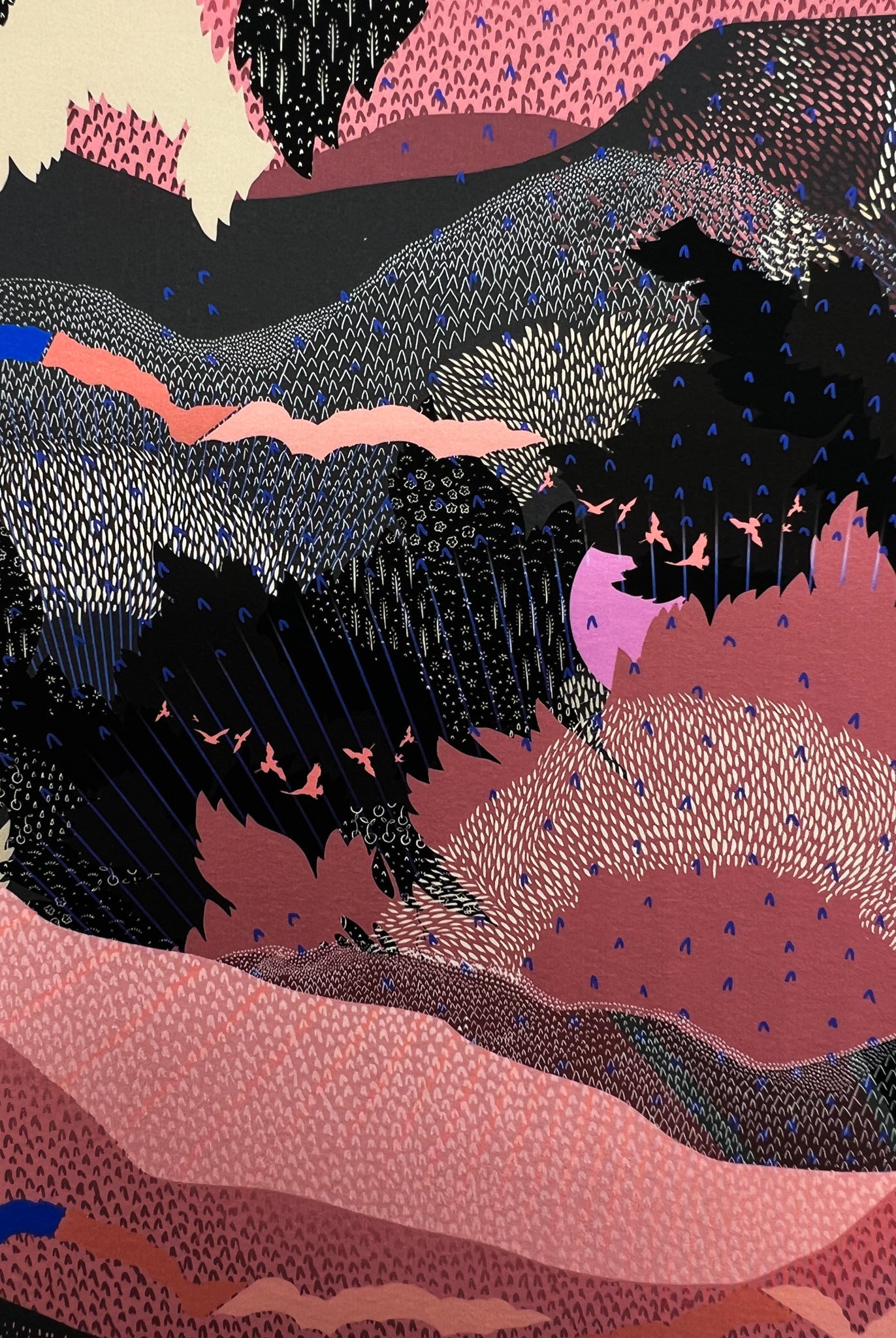 A close up of a giclee print in black and pink with a landscape design and bright pink suns