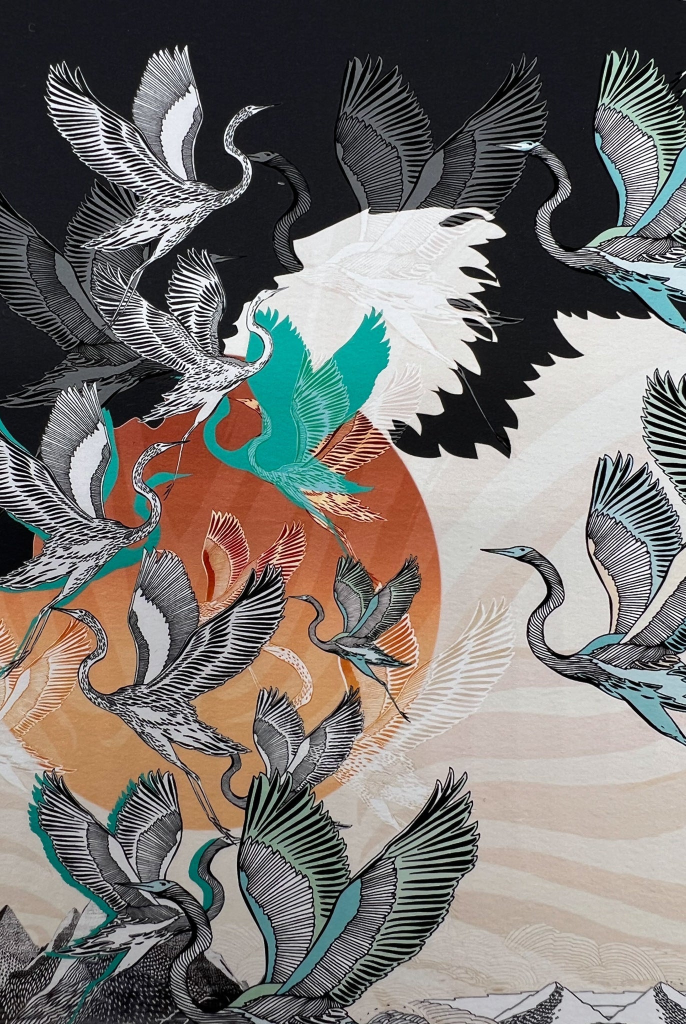 Close up of a Giclee print of a sunrise and stalk design in black, orange and blue