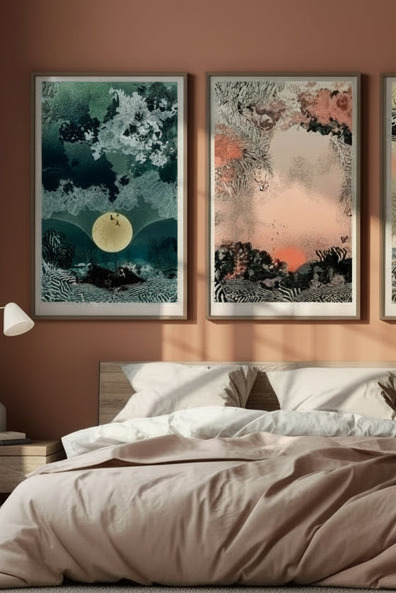 A mock up of a giclee print with Sunrise design in oranges and blacks in a wood frame, above a bed