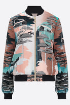 The front of a printed silk bomber jacket in green, coral and browns 