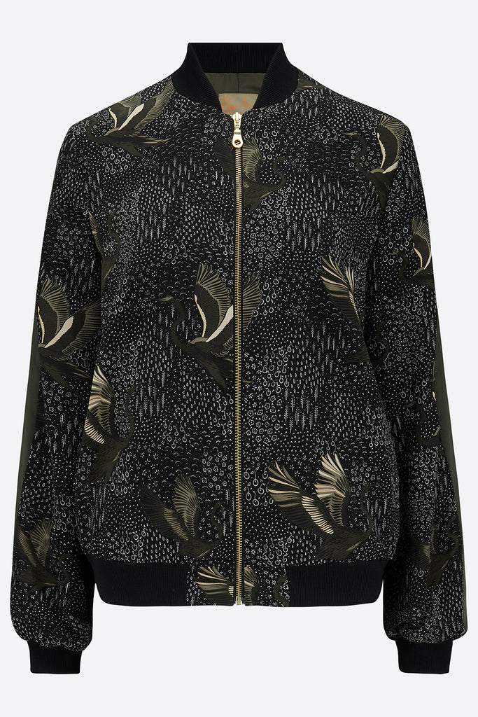 The front of a printed silk bomber in green and black