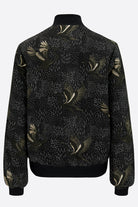 The back of a printed silk bomber in green and black