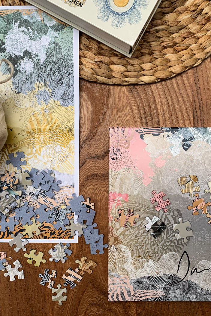 A printed jigsaw and jigsaw box of a yellow and orange landscape