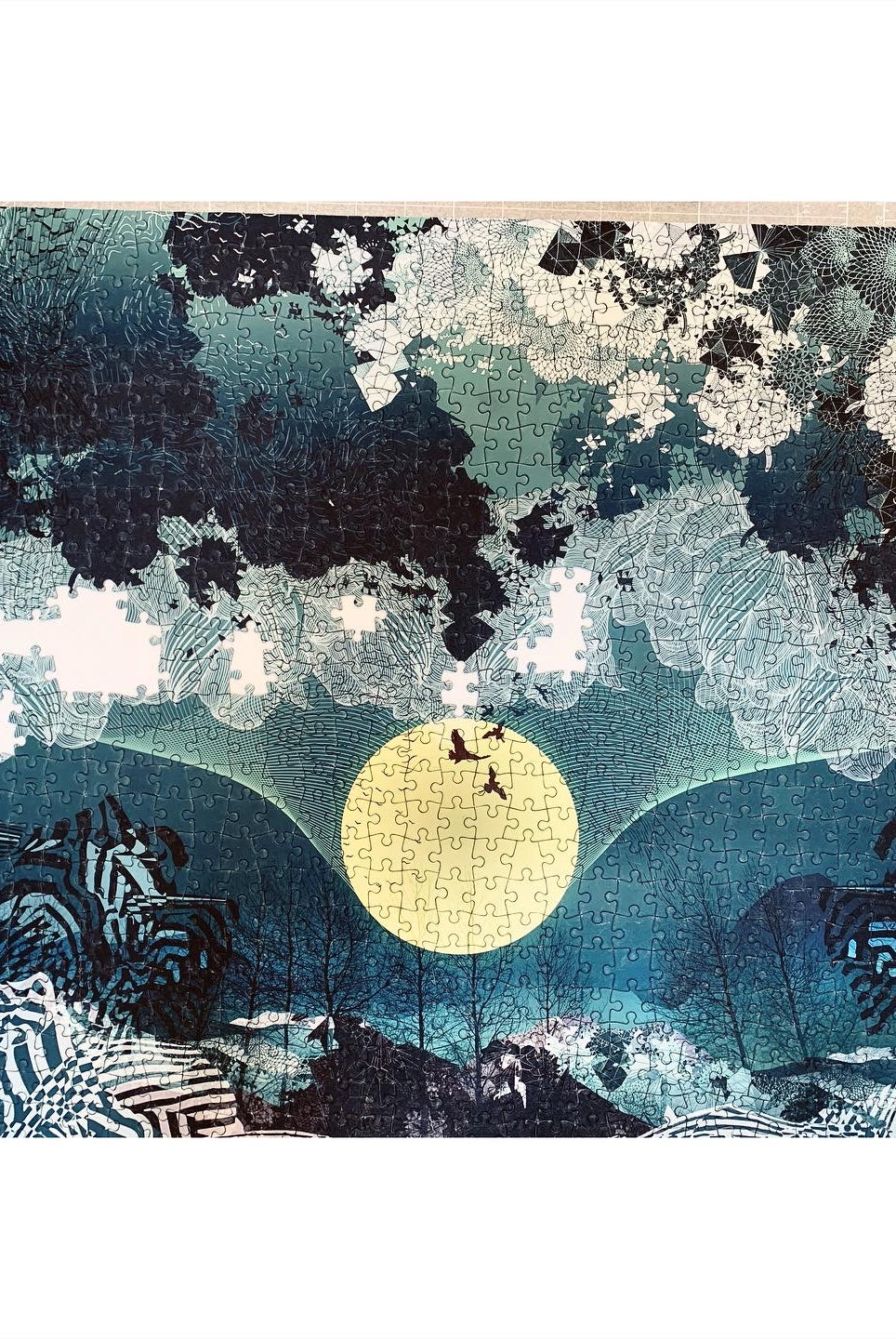 A printed jigsaw of a blue and black landscape