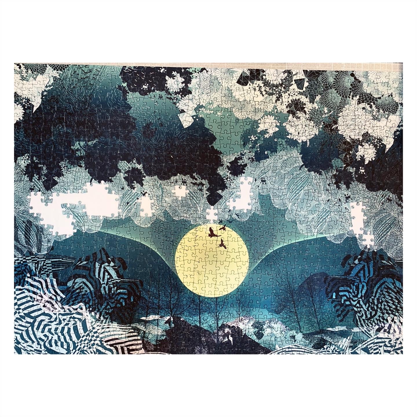 A printed jigsaw of a blue and black landscape