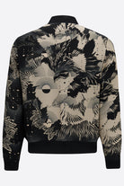 The back of a silk mens bomber jacker in a deep navy and cream print abstract floral print