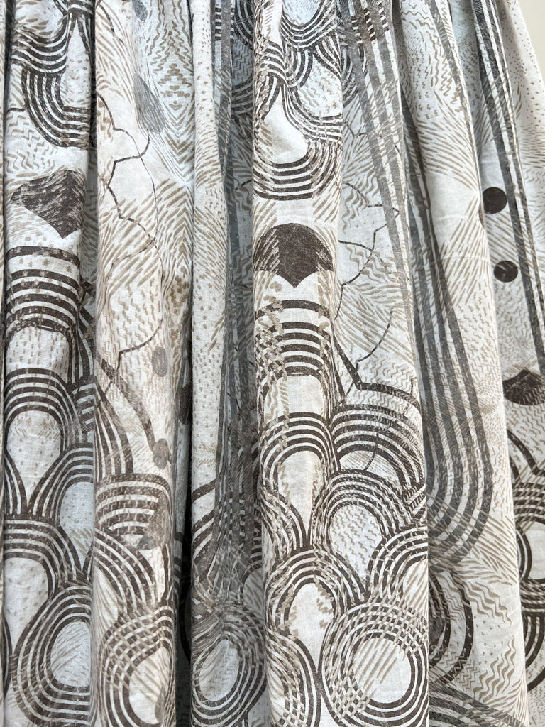 A close up of an organic cotton hand printed midi skirt in white and grey