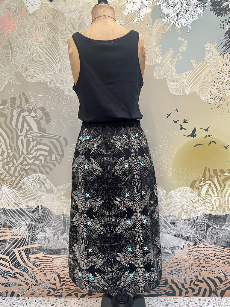 The back of a tencel twill handprinted midi skirt in black and white