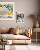 A mock up of a Giclee print in a white frame on a wall in front of a sofa