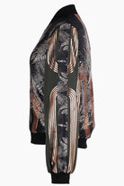 The side of a hand printed silk bomber bomber jacket with hand printed designs in black, olive green and rose gold