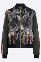 The front of a hand printed silk bomber bomber jacket with hand printed designs in black, olive green and rose gold