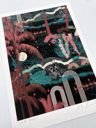 A giclee print of a landscape scene with palm trees and botanical plants in greens and wine red