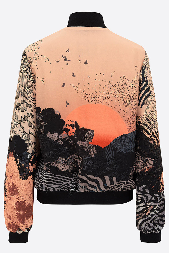 The back of a Silk bomber jacket in orange and black with sunrise design