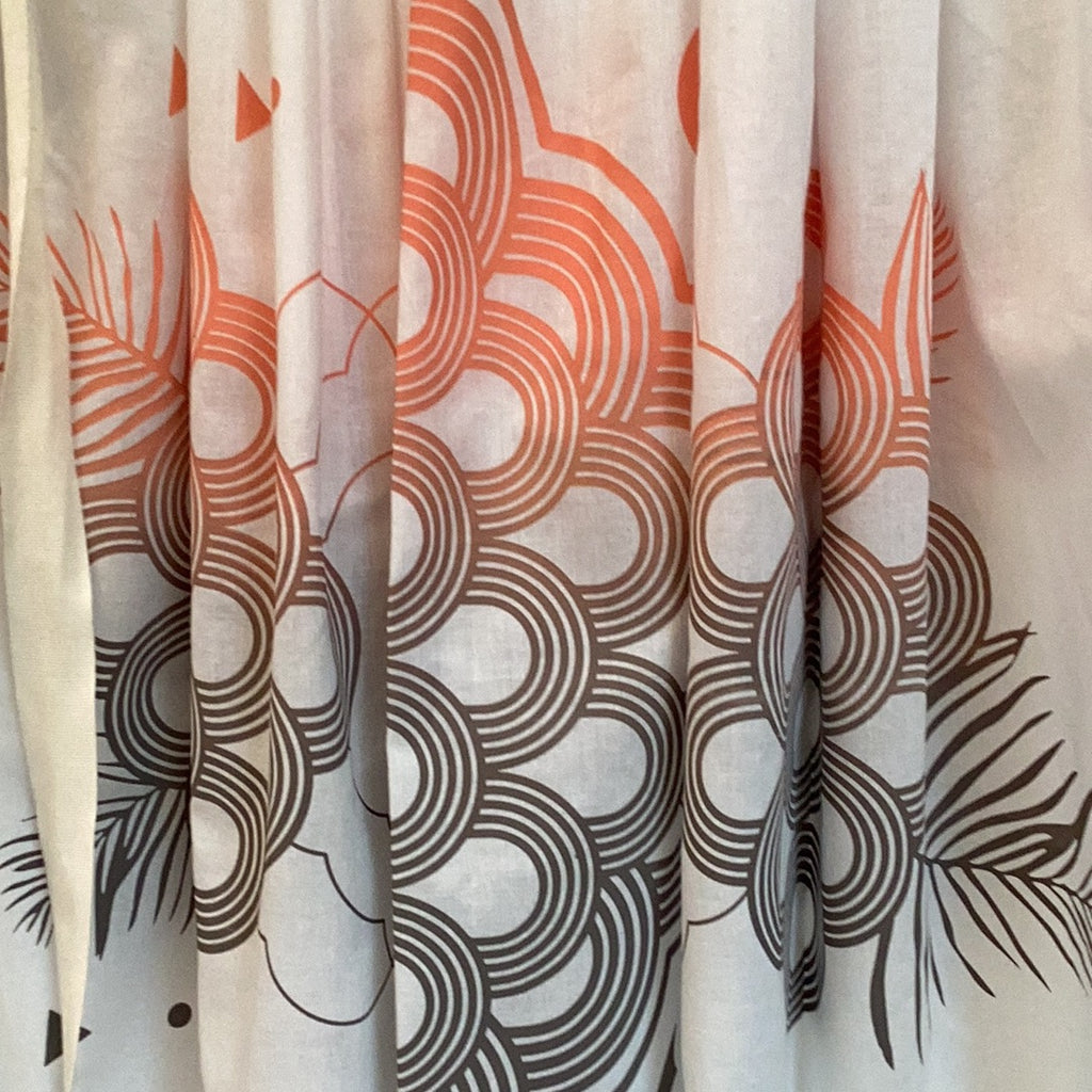 A close up of an organic cotton handprinted midi skirt in white, peach and grey