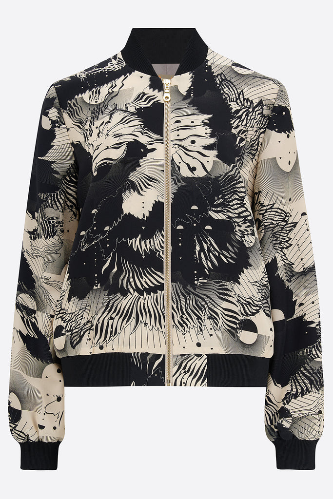 The front of a printed silk bomber jacket in a navy and cream abstract floral and geometric print