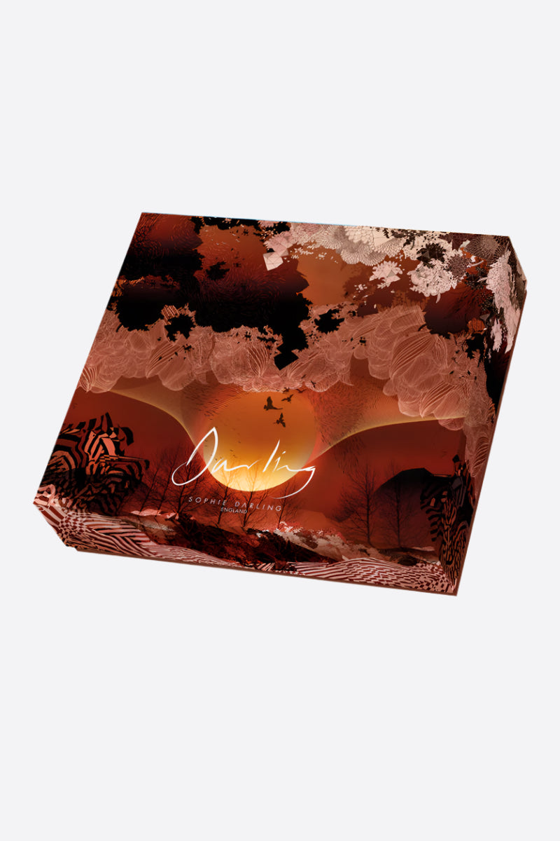 A printed jigsaw box with a sunrise design