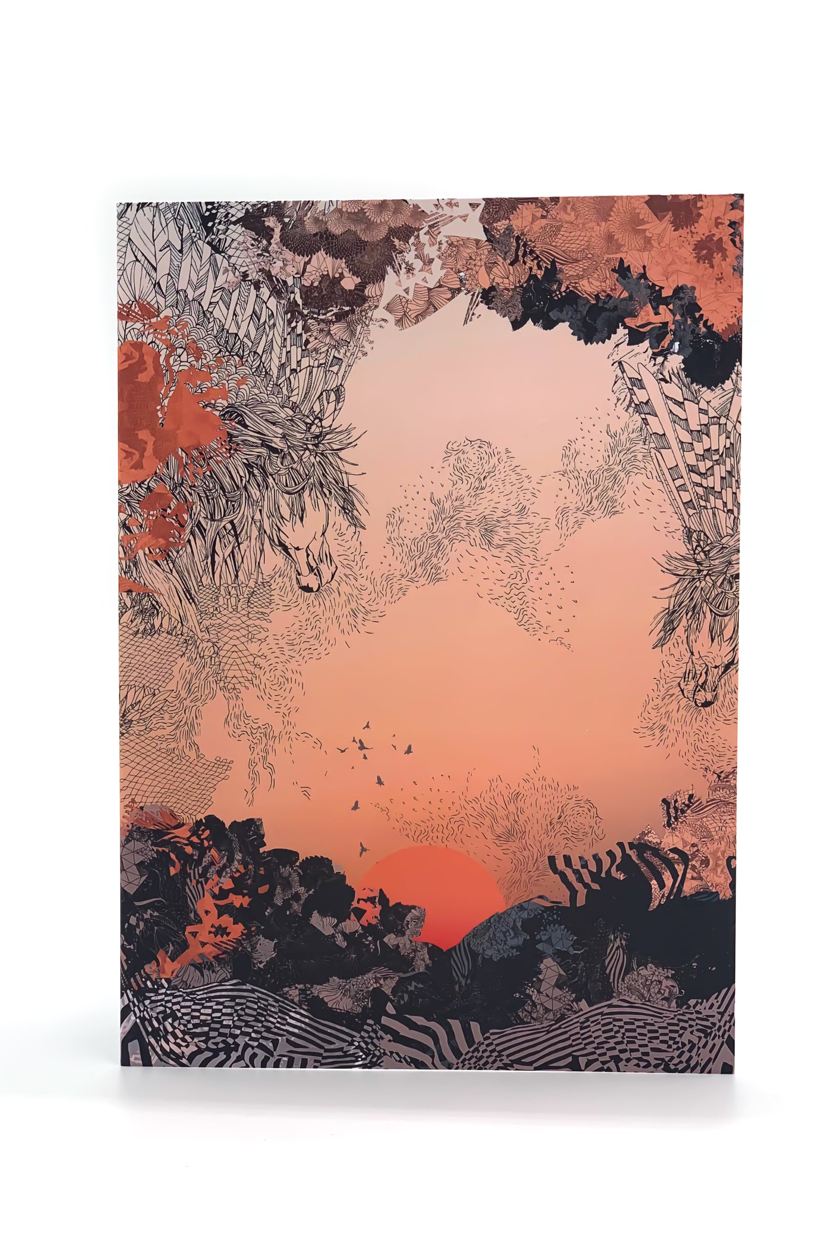 A greetings card with a sunrise design in orange and black