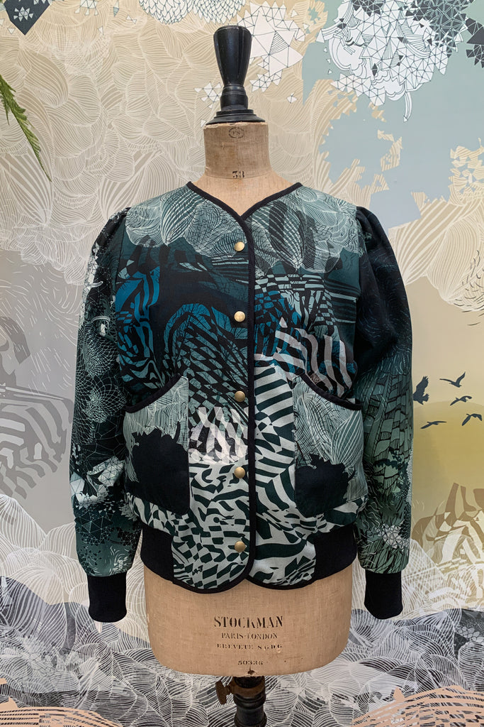 A cotton jacket with an intricate geometric patterns in shades of blue