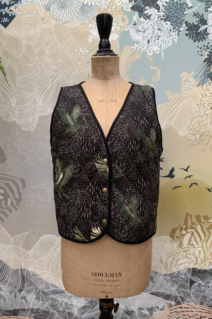 A cotton drill quilted waistcoat in black, green and white