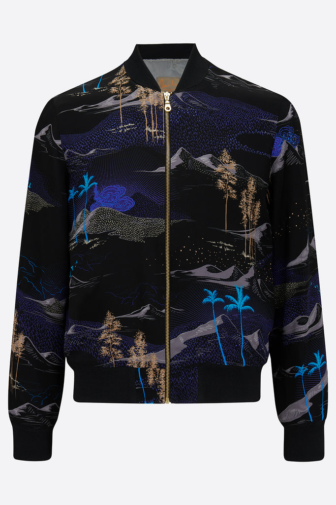 The front of a silk mens bomber jacket with a landscape all over print in black, bright blue and tan