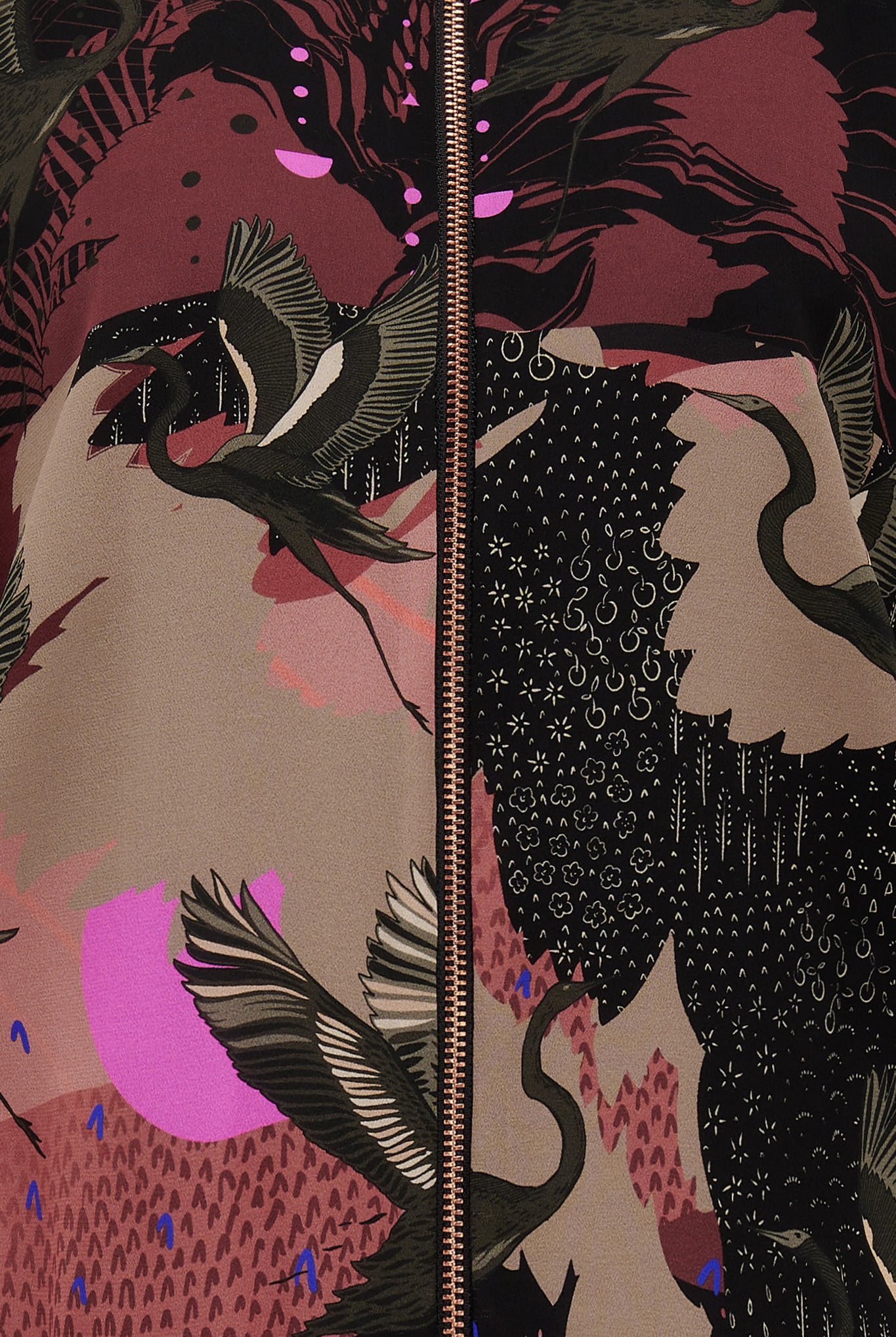 A close up of a silk printed bomber jacket in black and pink