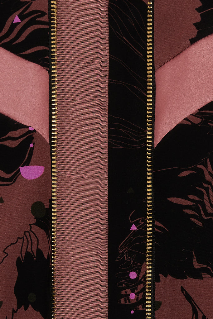 A close up of a silk printed bomber jacket in black and pink