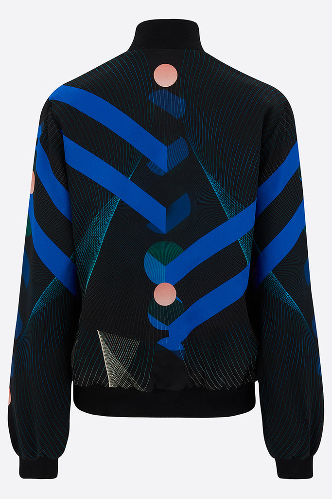 Back of a Silk Bomber Jacket with bold blue stripes against a geometric print with pink circles