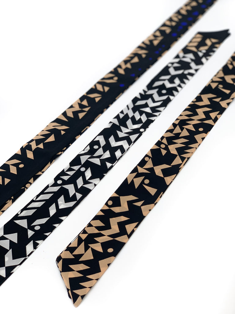 A silk printed necktie in white, black and yellow