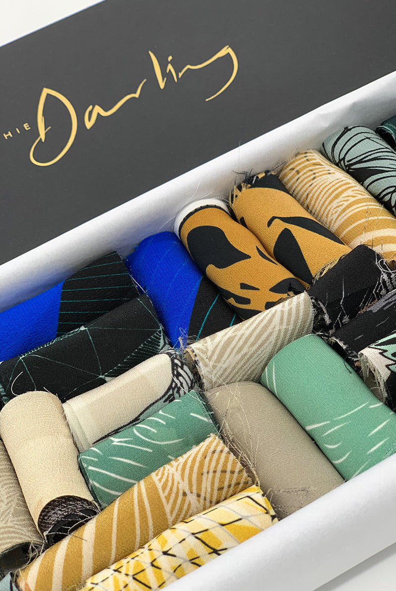 A ribbon box containing blue tone fabric pieces 