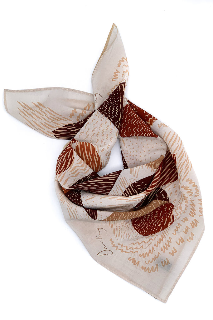 A silk printed scarf in earthy tones