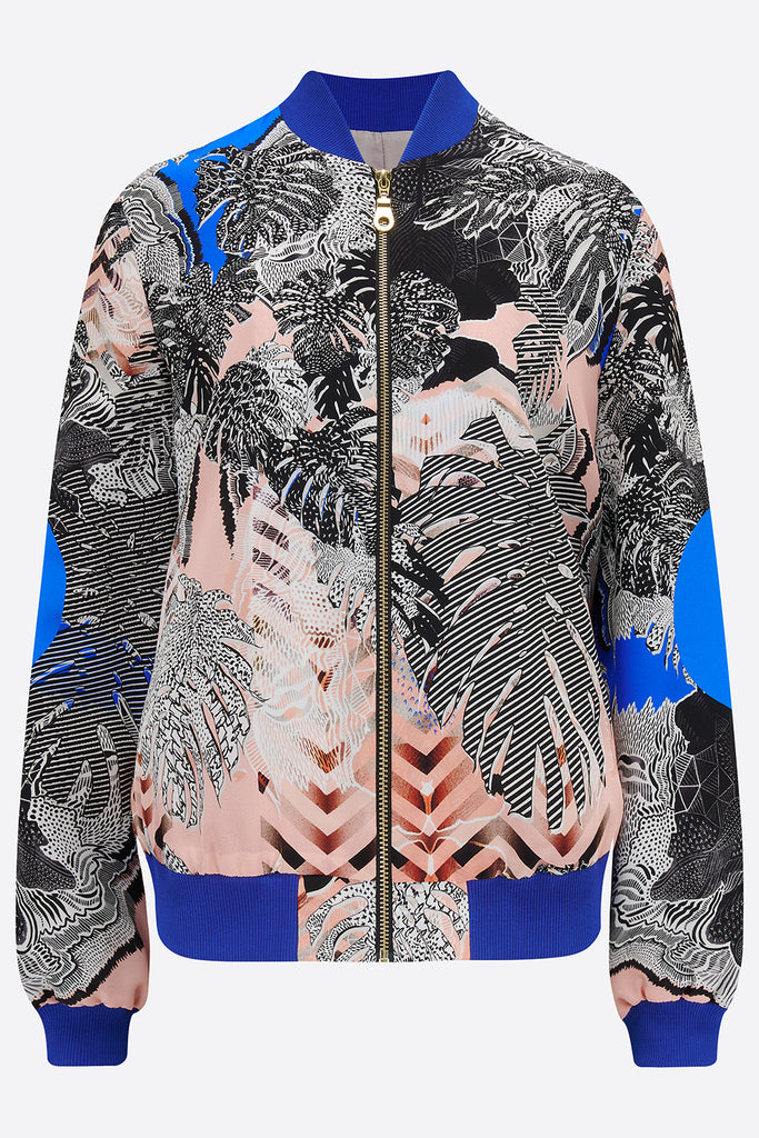 The front of a silk bomber jacket in blue, pink and monochrome tropical print