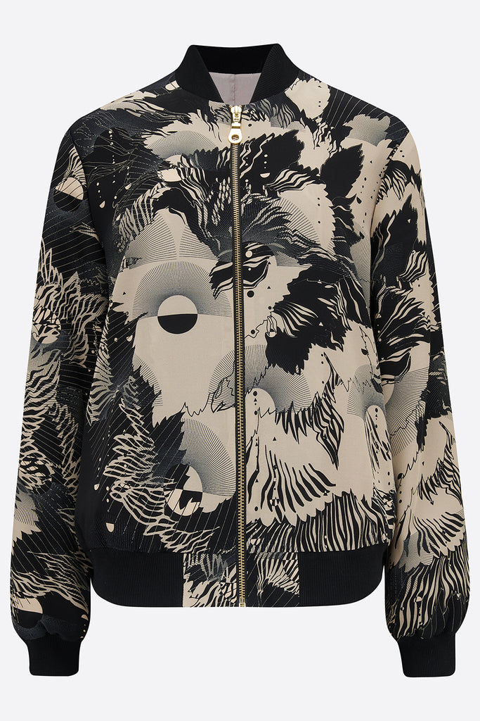 The front of a printed silk bomber jacket in grey and cream geometric floral design