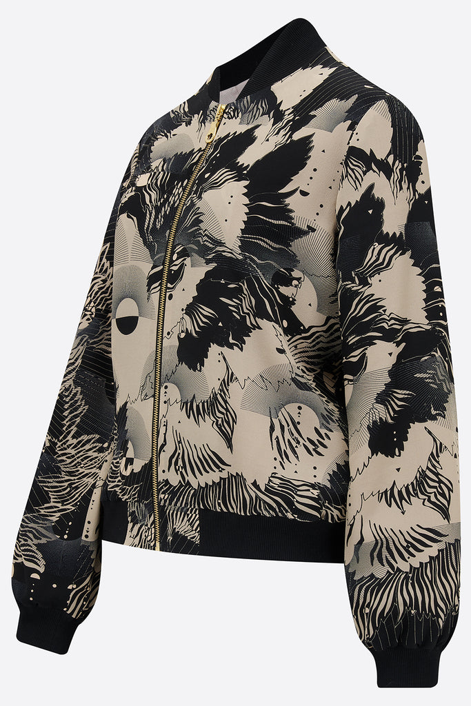 The side of a printed silk bomber jacket in grey and cream geometric floral design