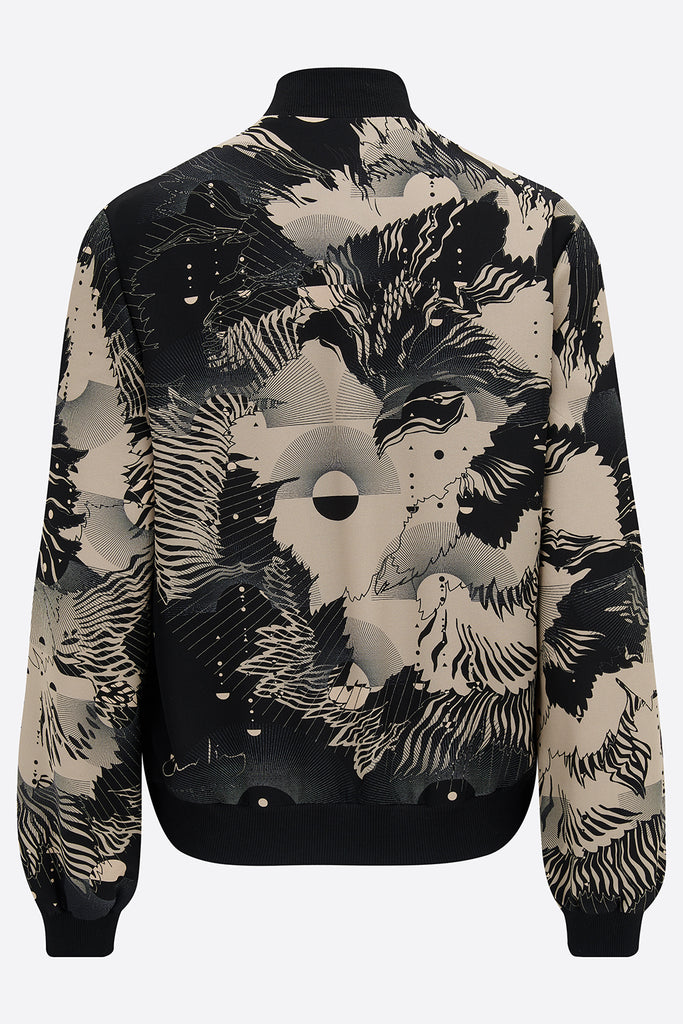 The back of a printed silk bomber jacket in grey and cream geometric floral design