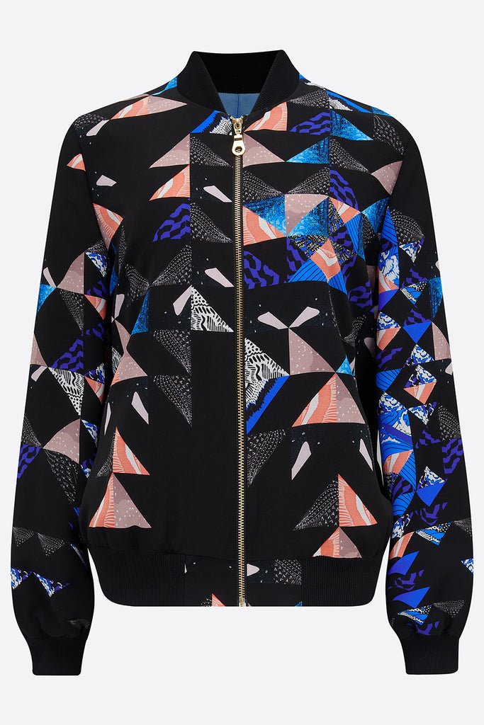 The front of a silk bomber jacket with a collaged geometric print in black, blue and pink