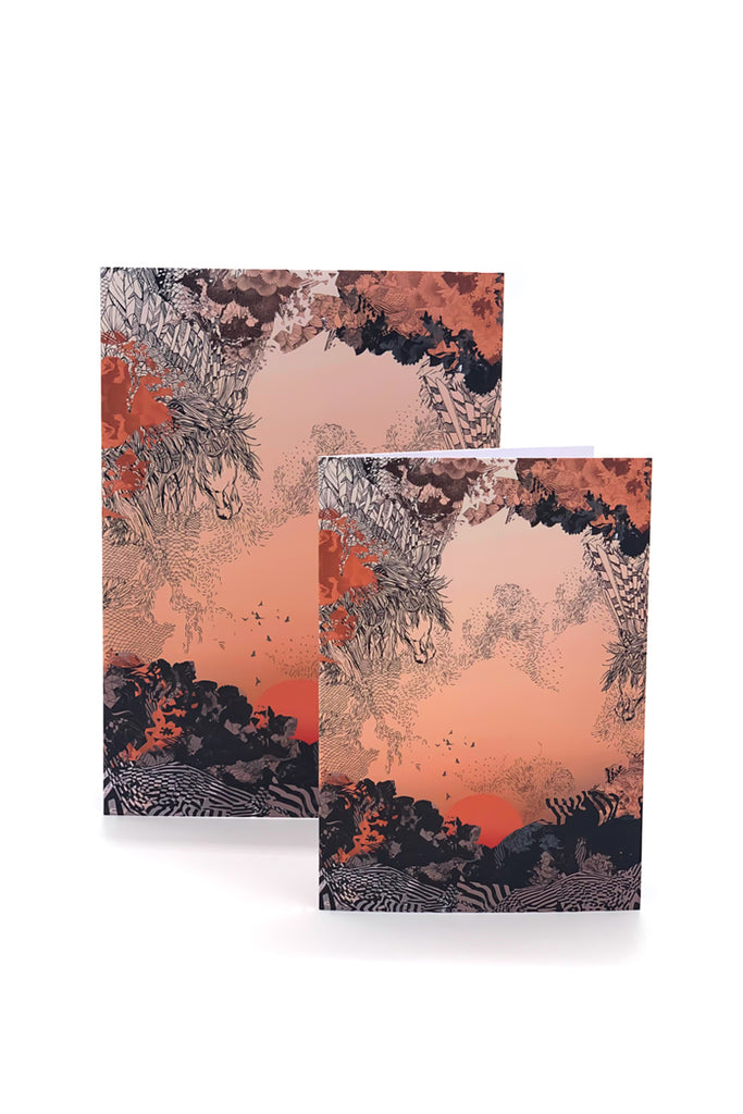A greetings card with a sunrise design in orange and black
